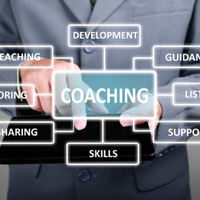 a diagram that has Coaching as the center that is overlayed infront of a person with hands behind the overlay
