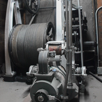 picture of mechanical wench and drum with wound cable for an elevator